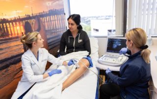 La Jolla Vein Care's Dr. Lucas discussing Ultrasound with patient