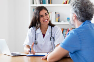 Friendly female doctor talking to patient | La Jolla Vein & Vascular Now Accepts Blue Shield Promise Medi-Cal