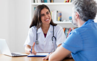 Friendly female doctor talking to patient